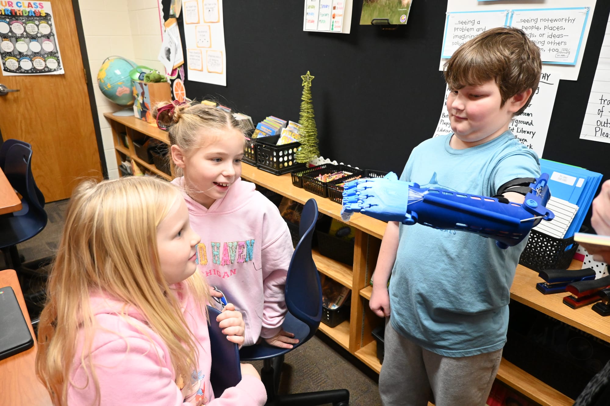 Grand Haven third-grader receives 3D prosthetic arm for Christmas from STEAM students